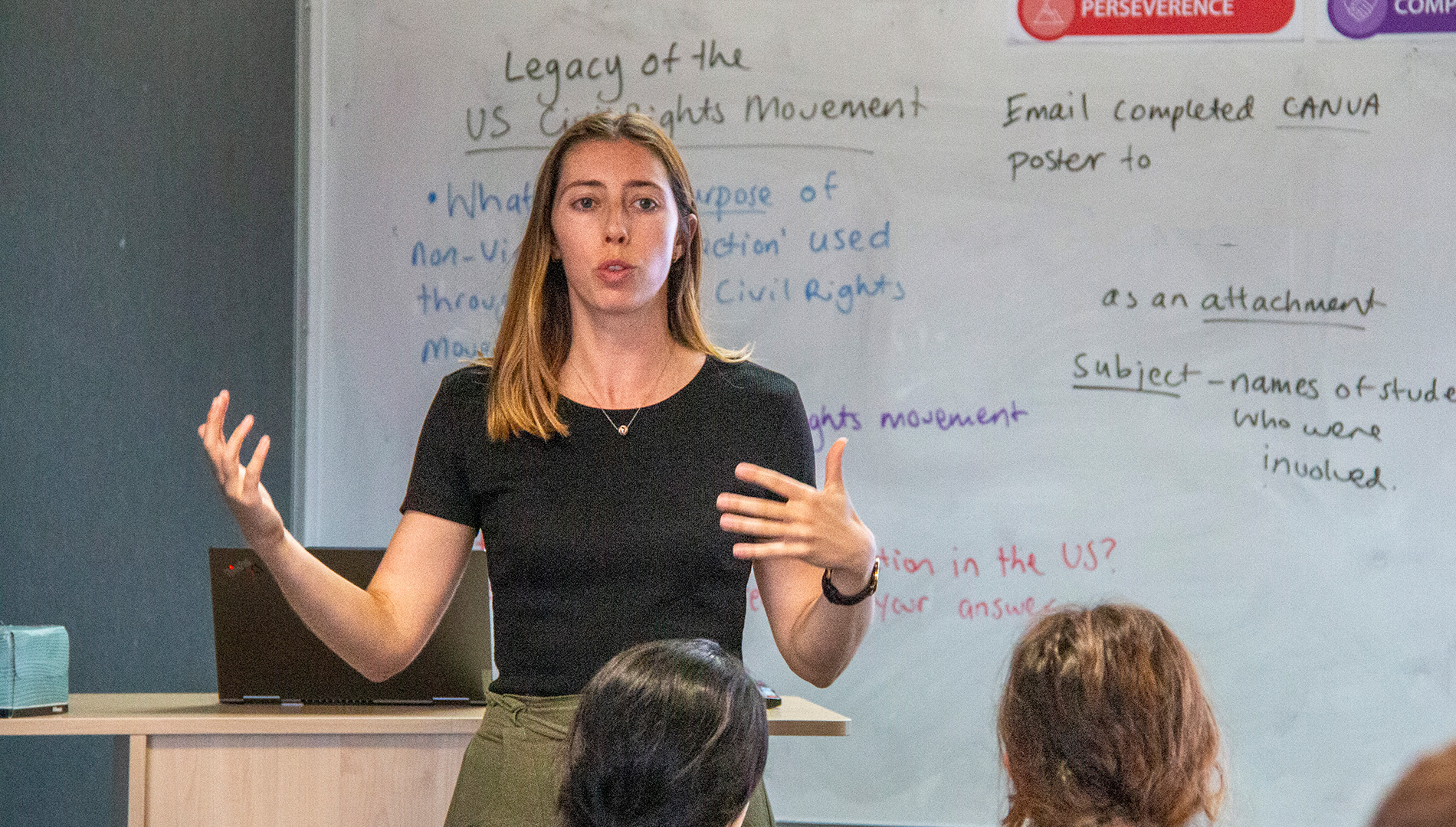 Teacher standing at the front of a classroom