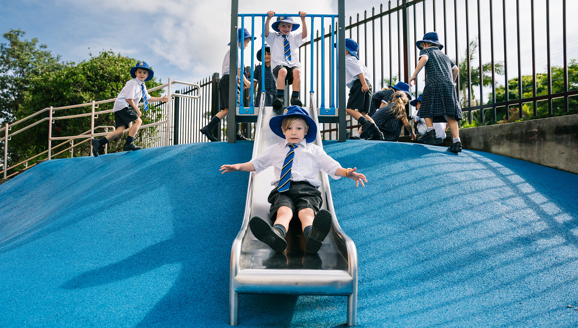 Boy sliding down slide