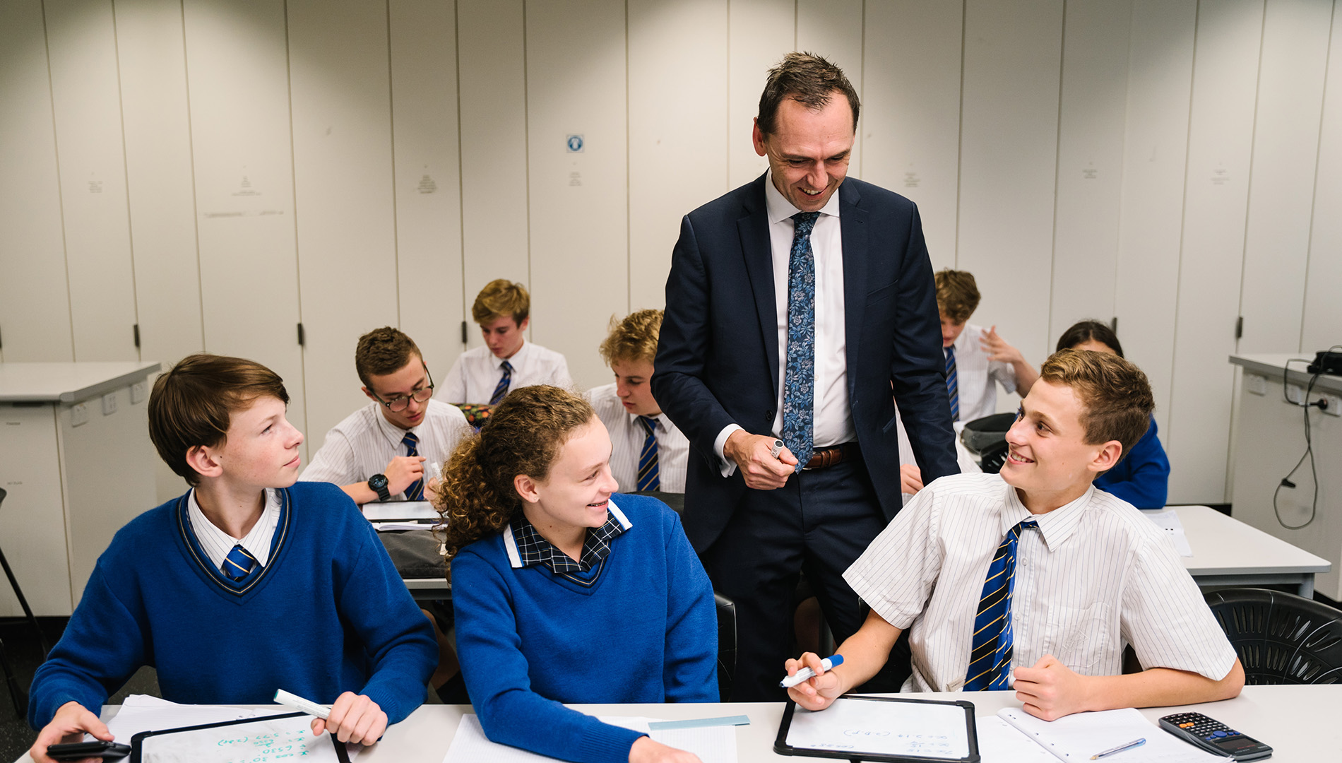 Image of Mark Liddell helping students in class.